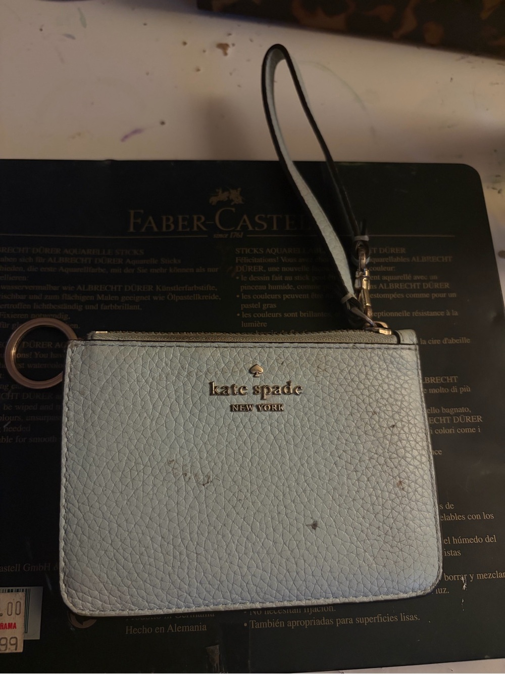 kate spade light blue pebbled leather wristlet with gold logo